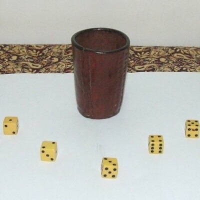 Attached photo of our original cacho cup and dice.