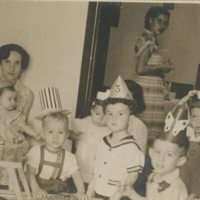 From left: Dita Gumpel (nee Ginsberg) with daughter, Lynn Gumpel, on her lap; Ralph Janowitzer, Niko Sifnaghel, (in rear) Edith Koppel (nee Wellisch), Fred Grunewald, and Peter Albers