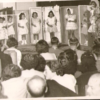Photograph of girls as dolls must have been taken in the 1950's and the children I recognize are: Myriam Abramsohn, the one with the hat; and me, the one with the flowered dress, to her left.  The picture was taken at the Jewish Association downtown Quito.  Asociacion Israelita de Quito?